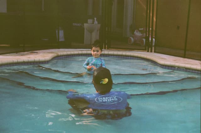 Swimming instructor teaching at home pool