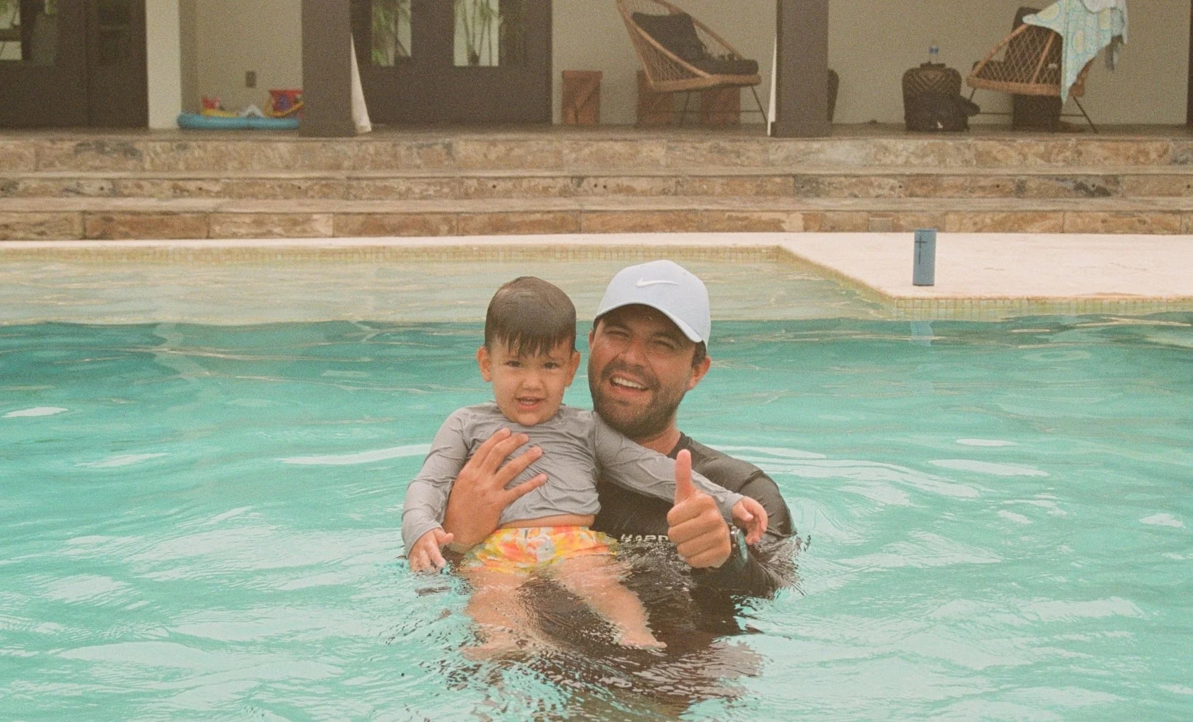 Children learning to swim with instructor